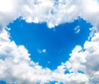 clouds forming heart shaped opening in sky